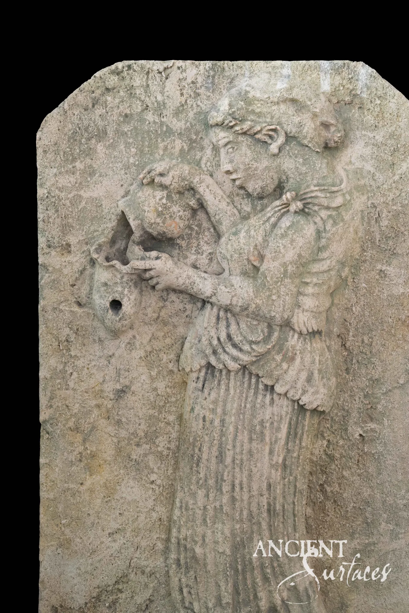 Reclaimed limestone wall fountain carved in relief with a classical maiden pouring water from an amphora