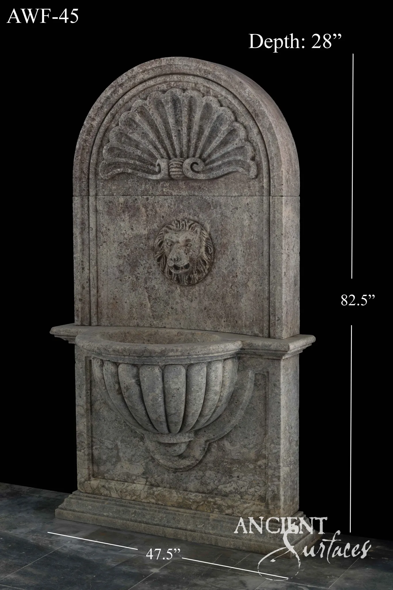 Tall reclaimed limestone wall fountain with a scallop-shell crest, lion-mask spout and fluted half-shell bowl